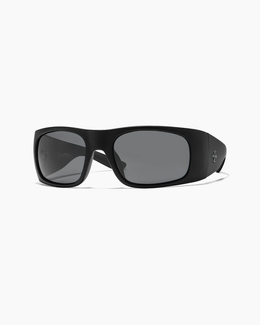 Transmitter sunglasses by Noa Deane in matte black with polarized lenses, side view showing temple emblem