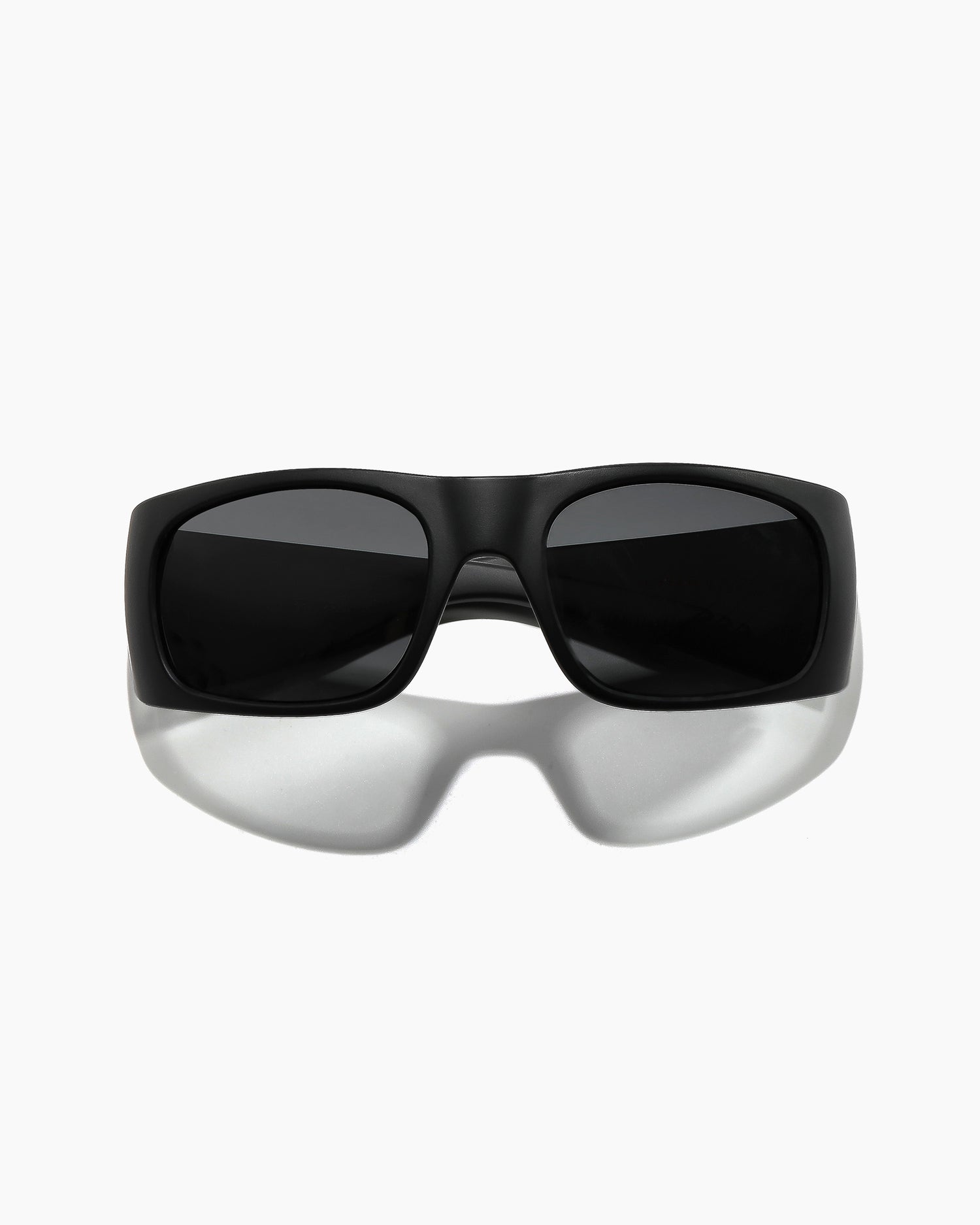 Transmitter sunglasses by Noa Deane in matte black with polarized lenses, front view from a lower angle
