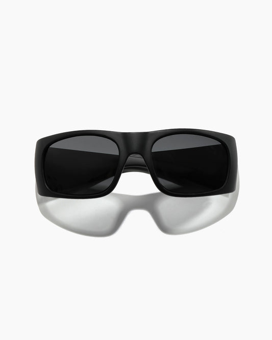 Transmitter sunglasses by Noa Deane in matte black with polarized lenses, front view from a lower angle