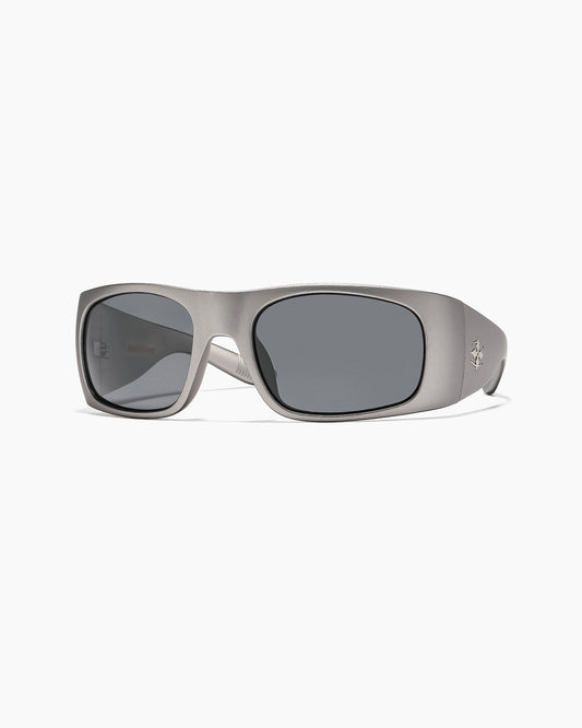 Matte gunmetal Transmitter sunglasses with dark grey polarized lenses, front view showing temple logo.