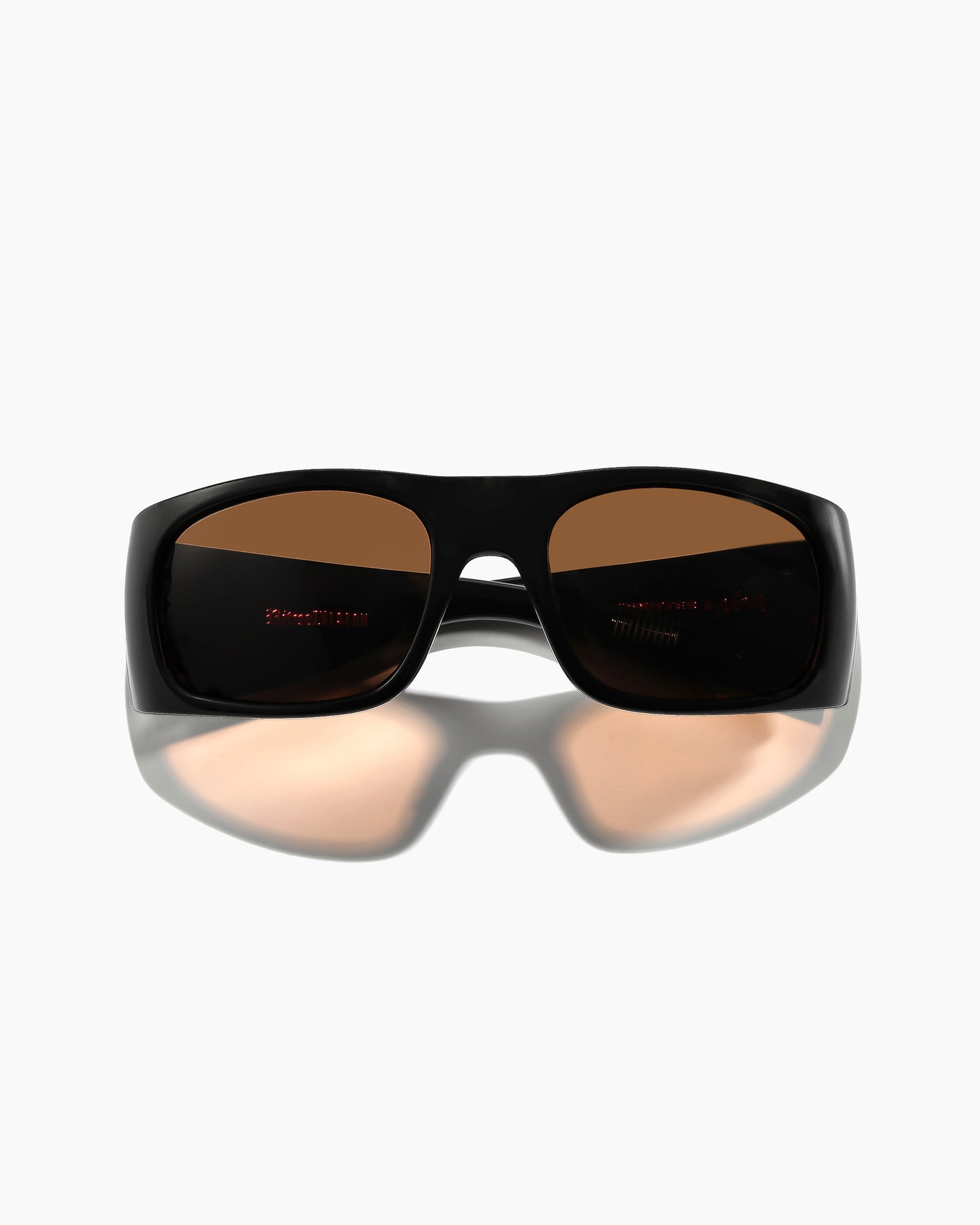 Transmitter by Noa Deane polished black frame with bronze polarized lenses front close up